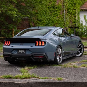 View of RTR Rocker Splitters installed on 2024+ Mustang rear three quarter view